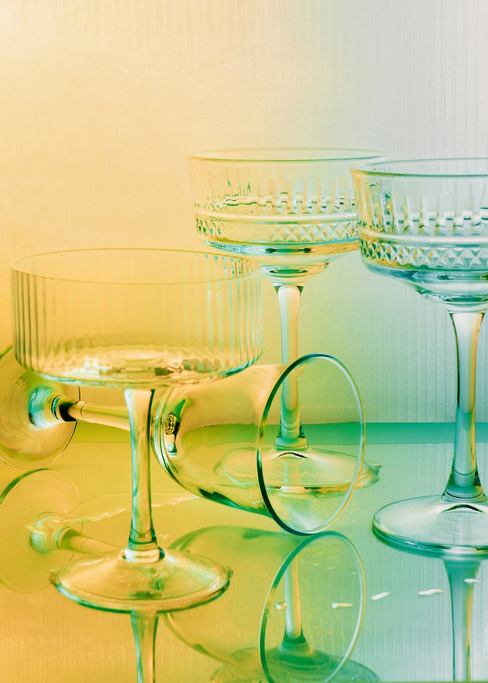 three wine glasses sitting on top of a table