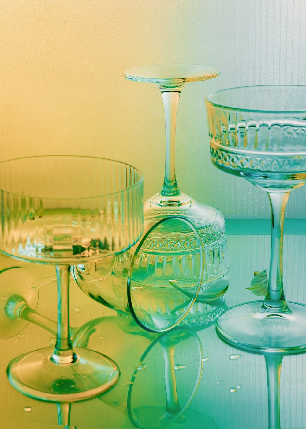three wine glasses and a wine glass on a table