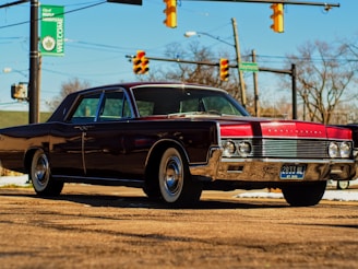 a red and black car parked on the side of the road