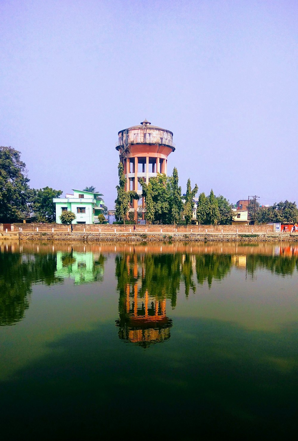 a large body of water with a building in the background