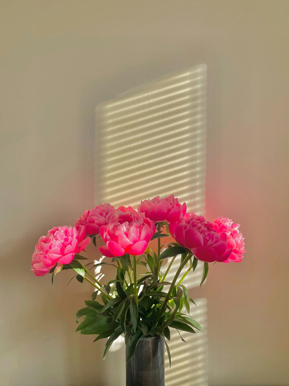 a vase filled with pink flowers on top of a table