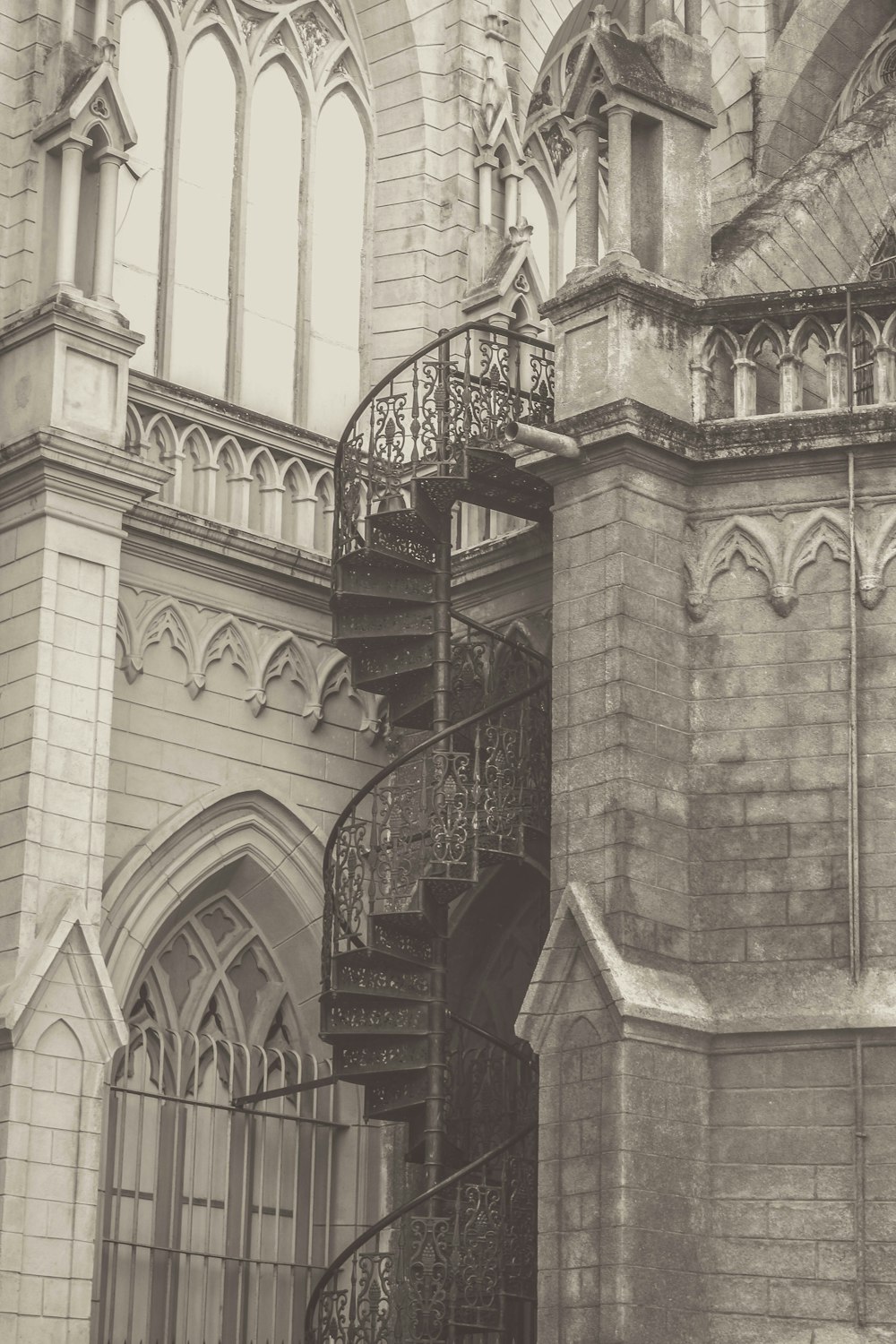 a black and white photo of a spiral staircase