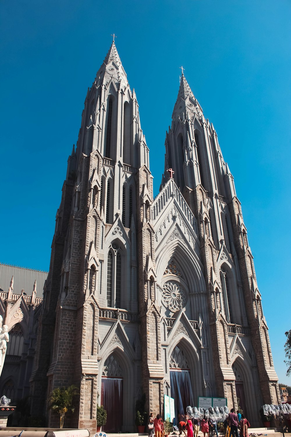 a group of people standing in front of a large cathedral