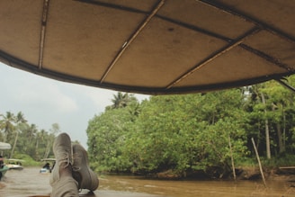 a person laying on a boat in a river
