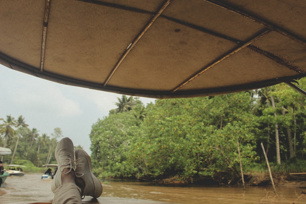 a person laying on a boat in a river