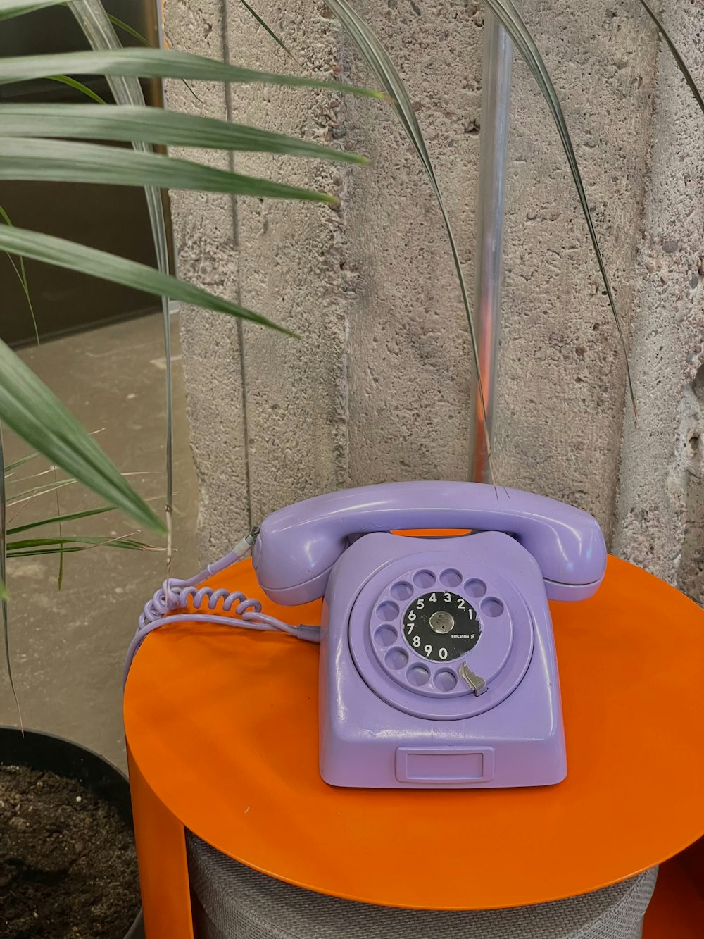 a purple phone sitting on top of an orange table