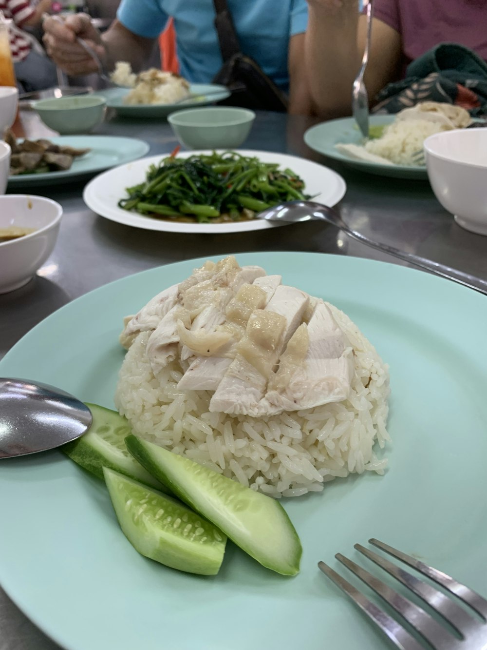 a plate of rice and cucumbers on a table