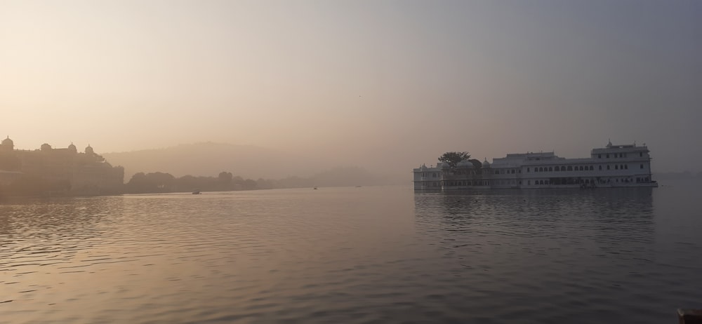 a large body of water with a building in the background