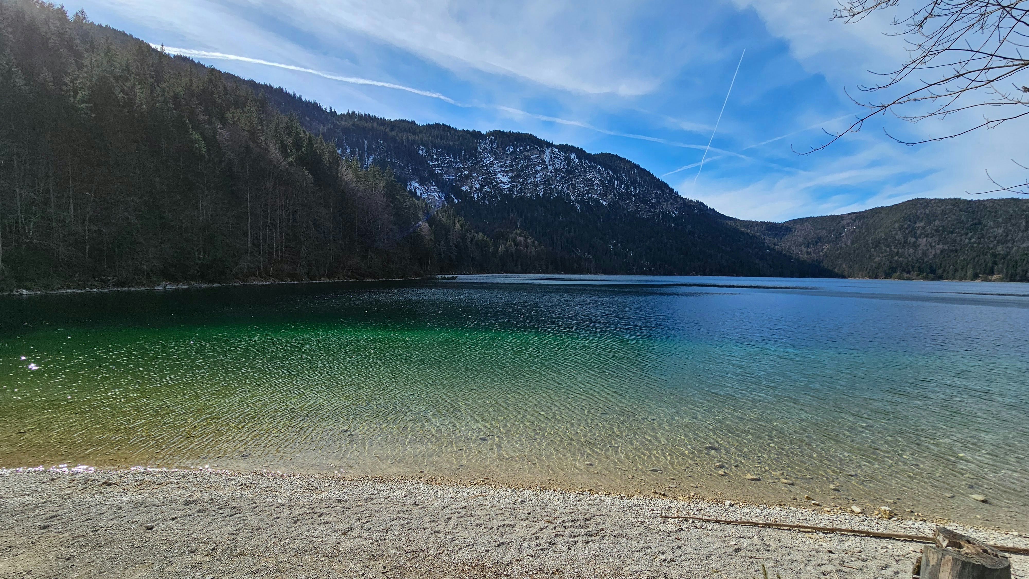 a body of water surrounded by mountains and trees