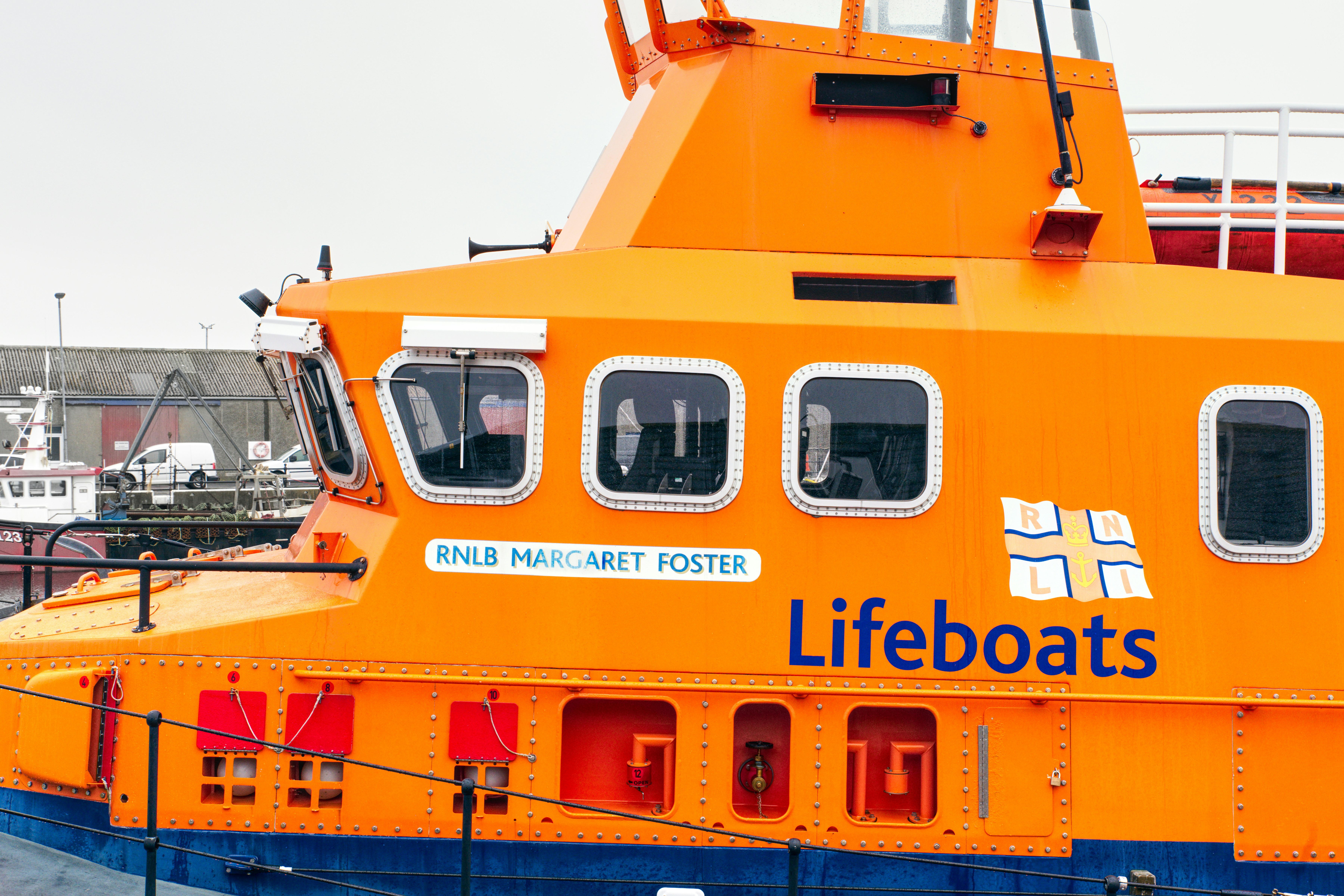 a large orange boat sitting in a harbor