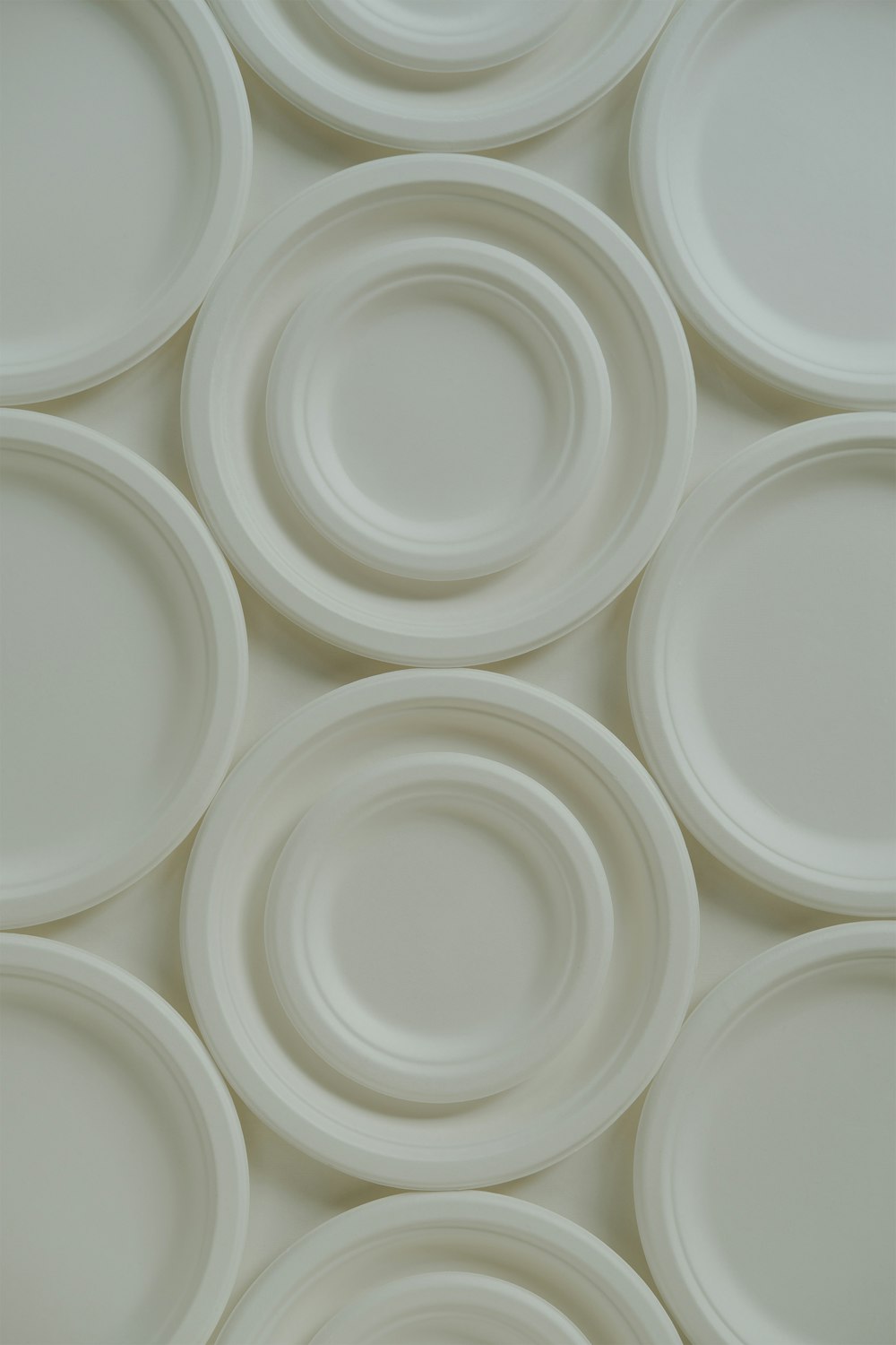 a close up of many white plates on a table