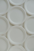 a bunch of white plates stacked on top of each other