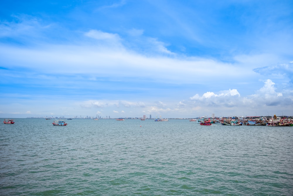 a group of boats floating on top of a large body of water