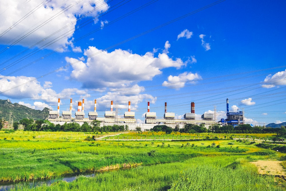 a power plant in the middle of a green field