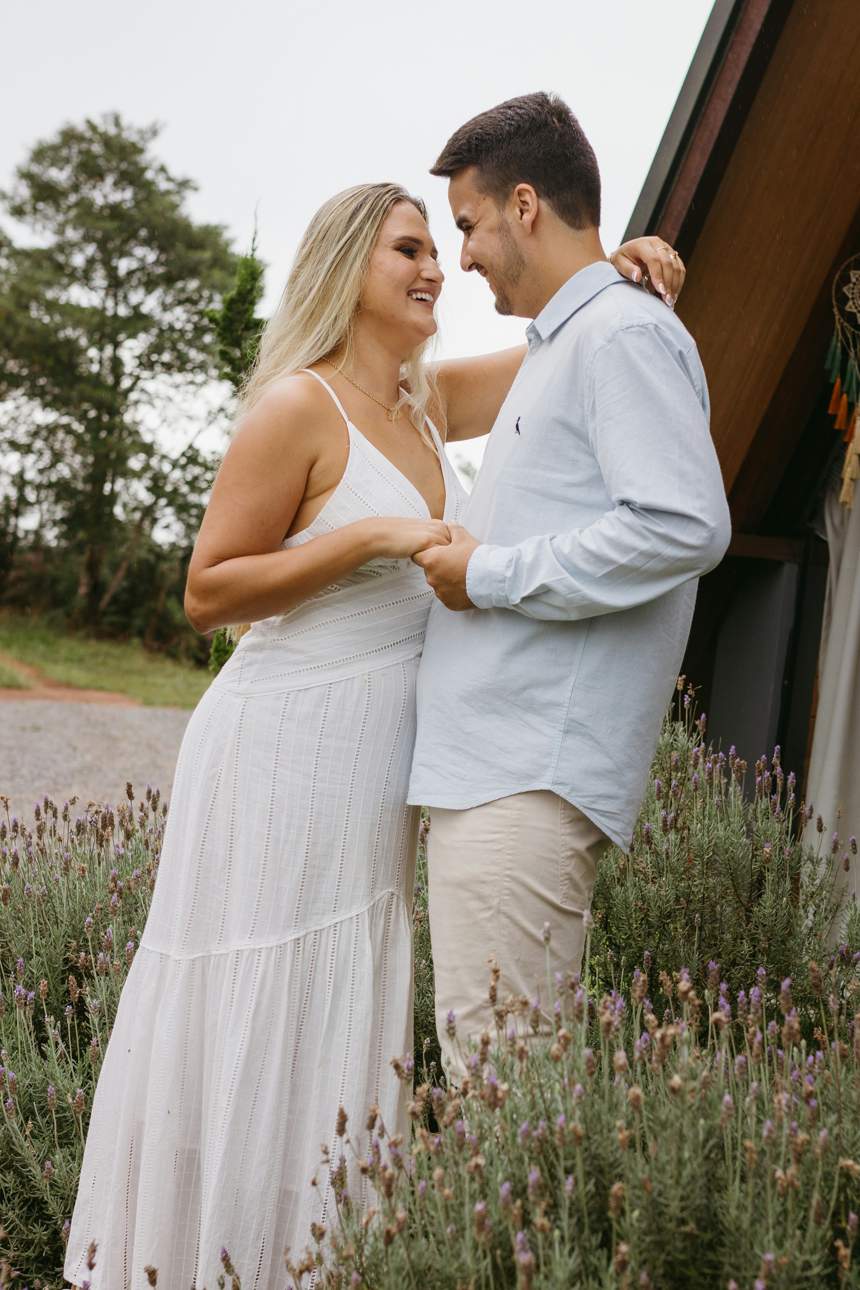 a man and a woman standing in a field of lavender