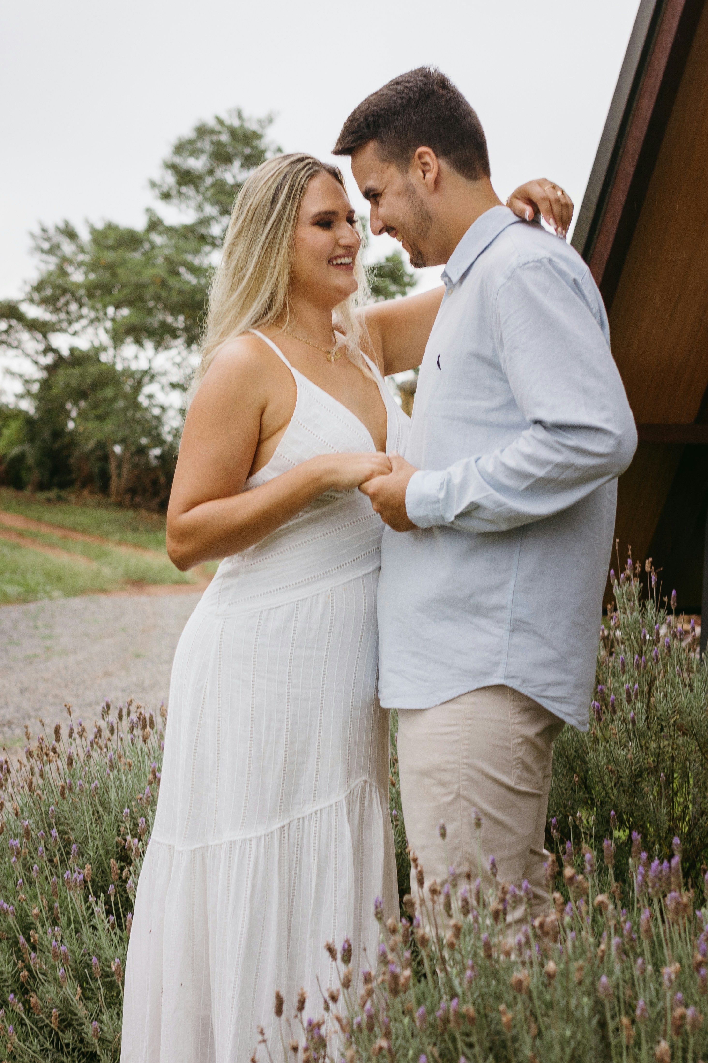 a man and a woman standing next to each other in a field