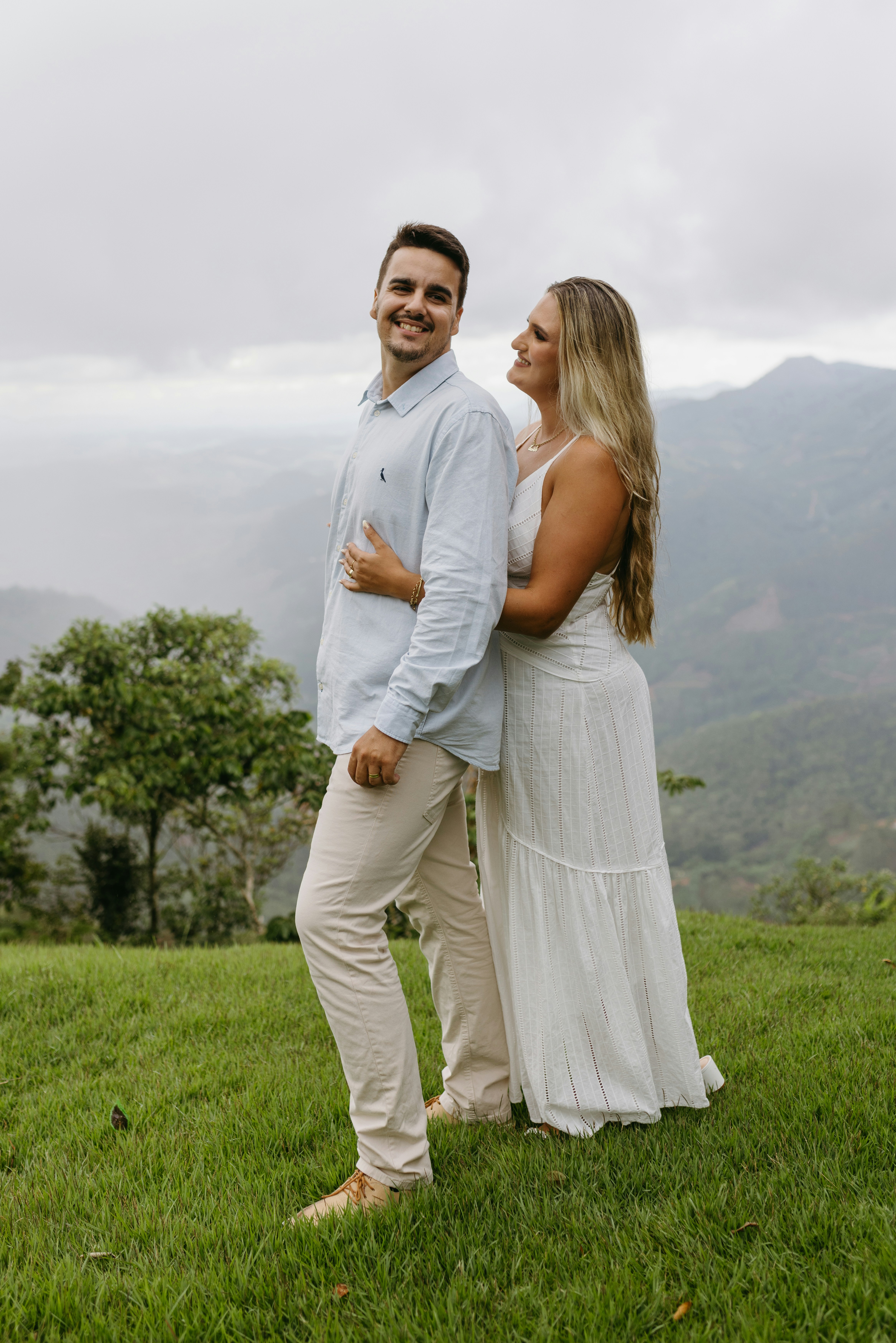 a man and a woman standing in the grass