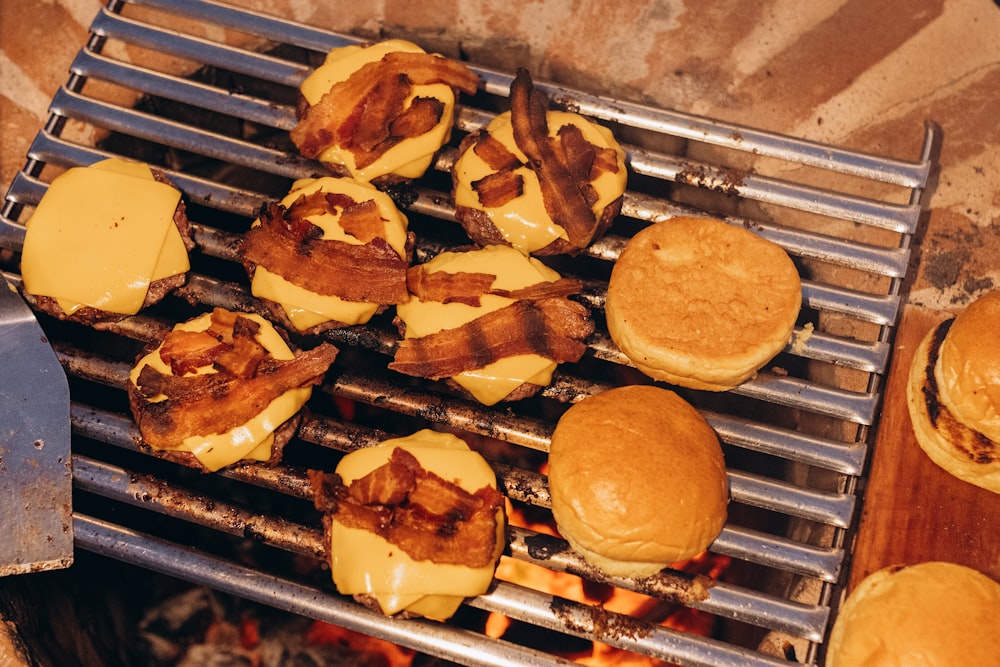 a bunch of hamburgers that are on a grill