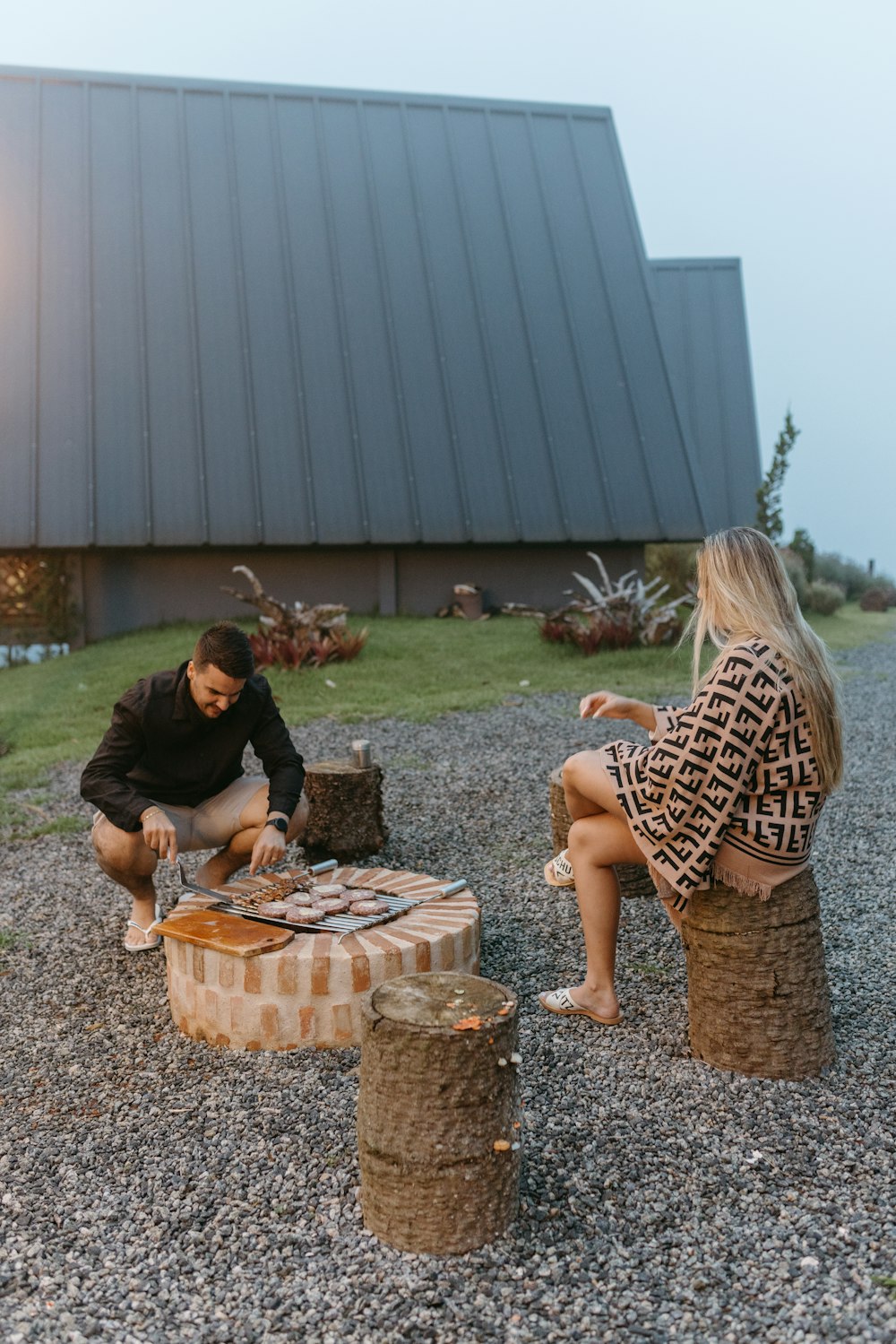 a man and a woman are sitting on logs