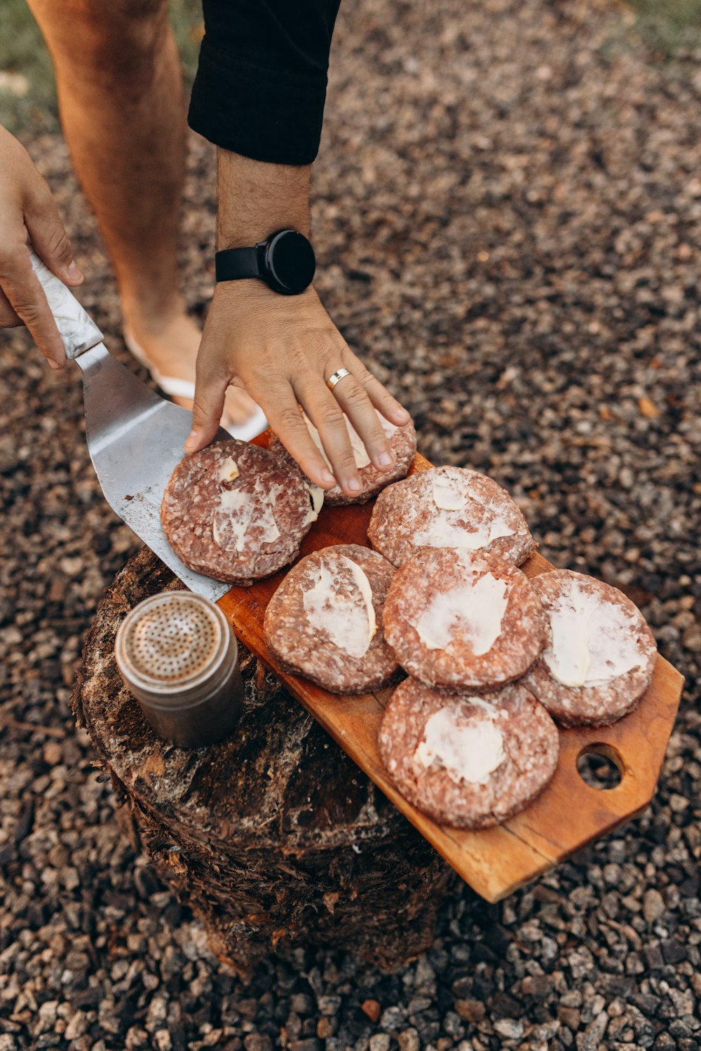 a person cutting up some food on a cutting board