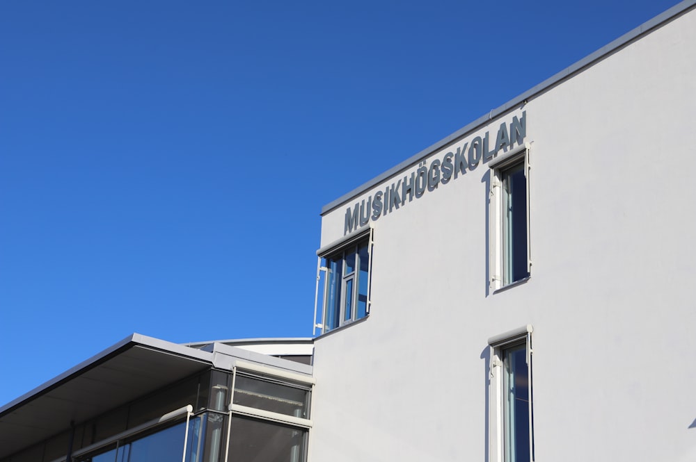 a white building with a blue sky in the background