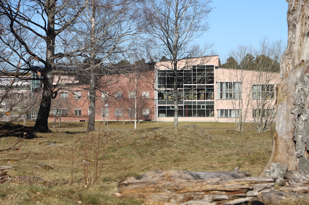 a building with a lot of windows and trees in front of it