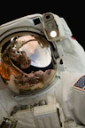 a reflection of an astronaut in his space suit