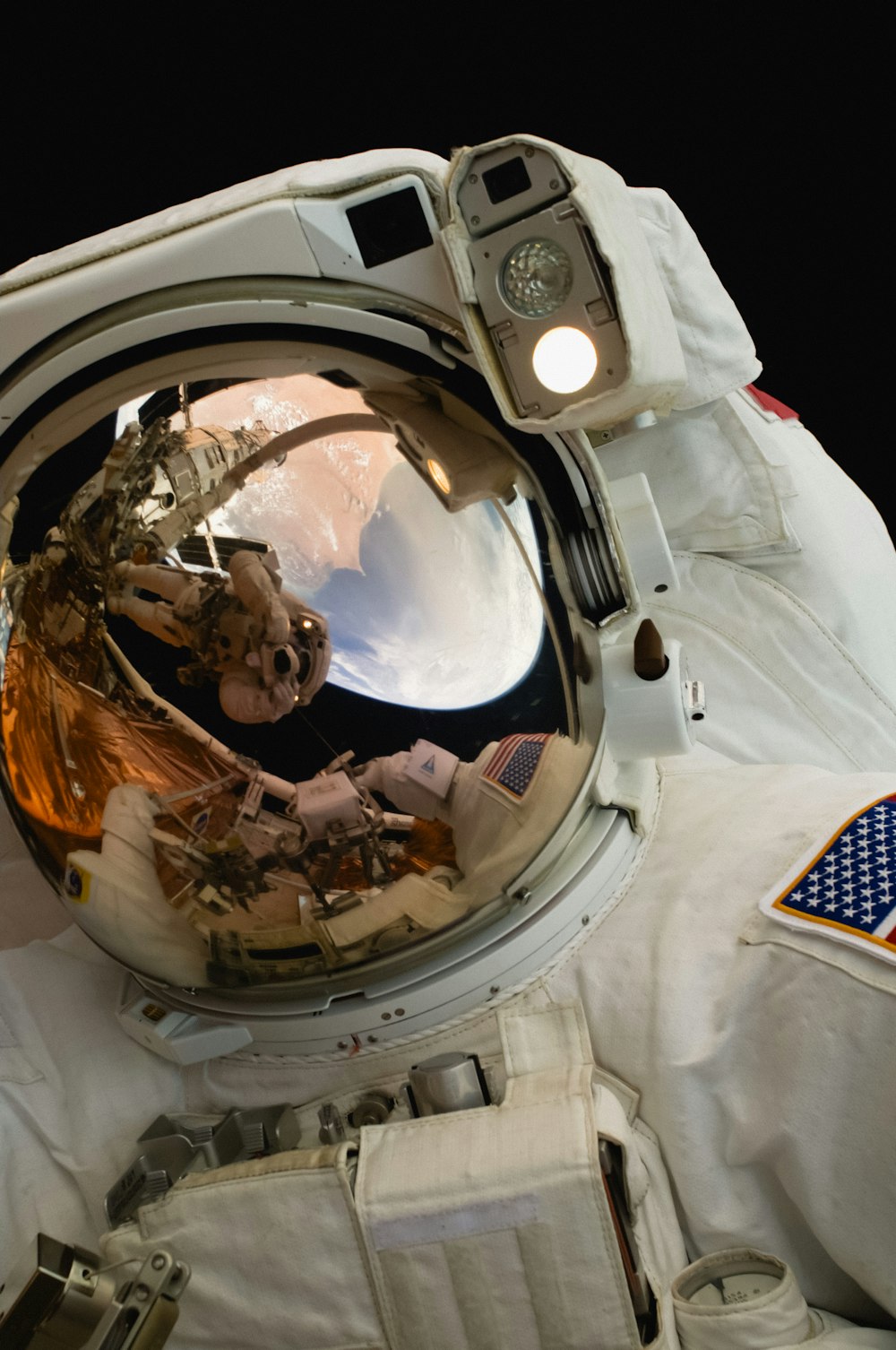 a reflection of an astronaut in his space suit