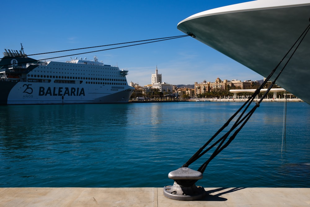 a large cruise ship in the water next to a dock