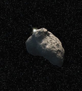 a large rock in the middle of a space filled with stars