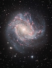 a spiral galaxy with stars in the background