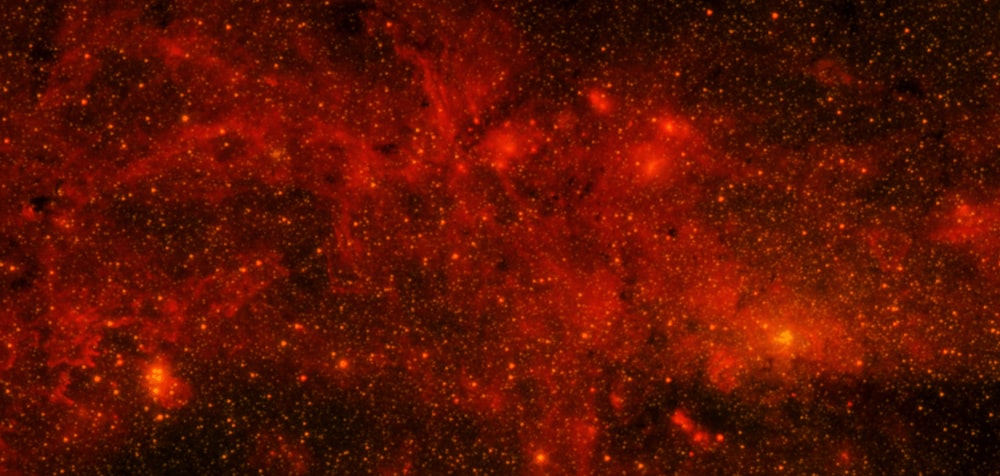 a red and black space filled with stars