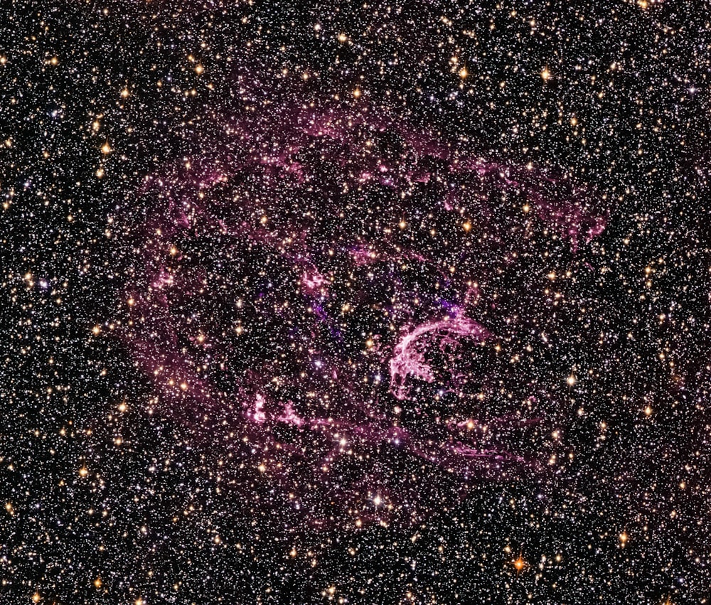 a star cluster in the middle of a night sky