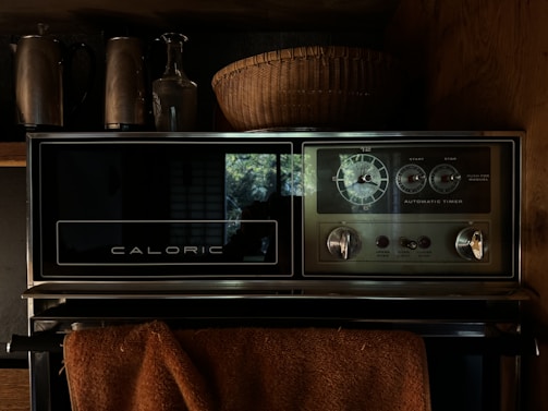 a microwave oven sitting on top of a stove top oven