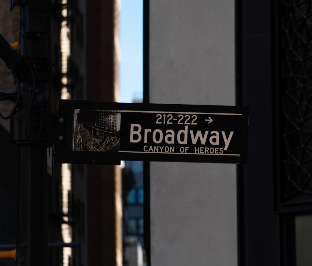 a black and white street sign on a pole