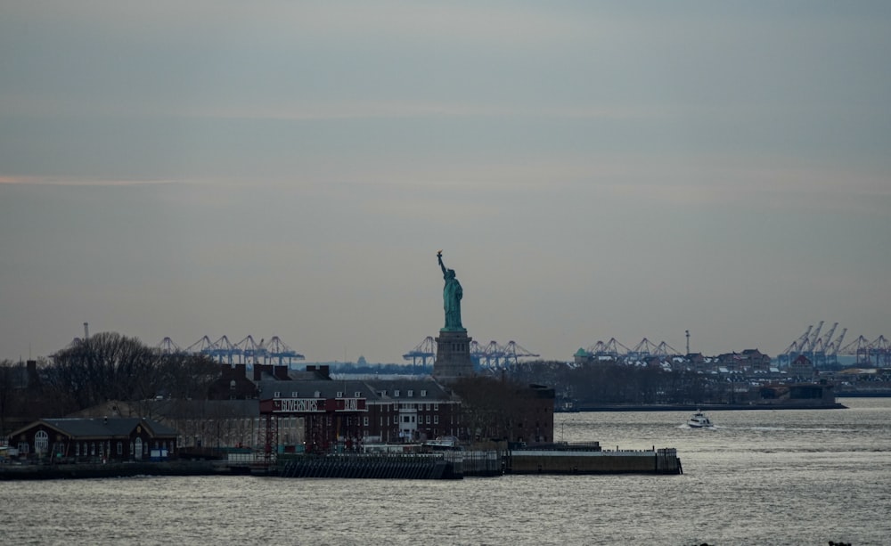 the statue of liberty is seen from across the water