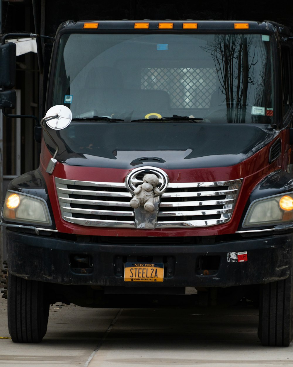 a red and black truck parked on the side of the road