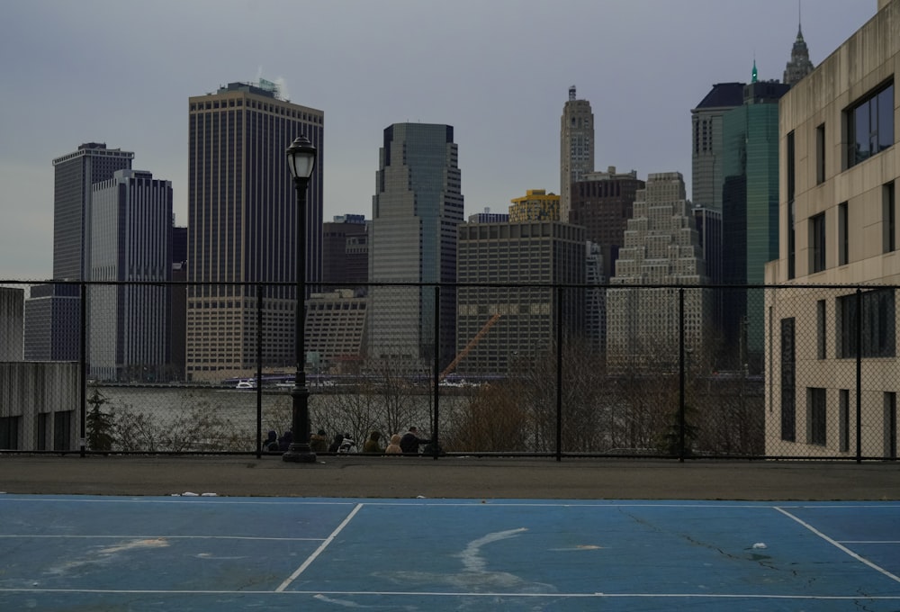 a tennis court in front of a city skyline