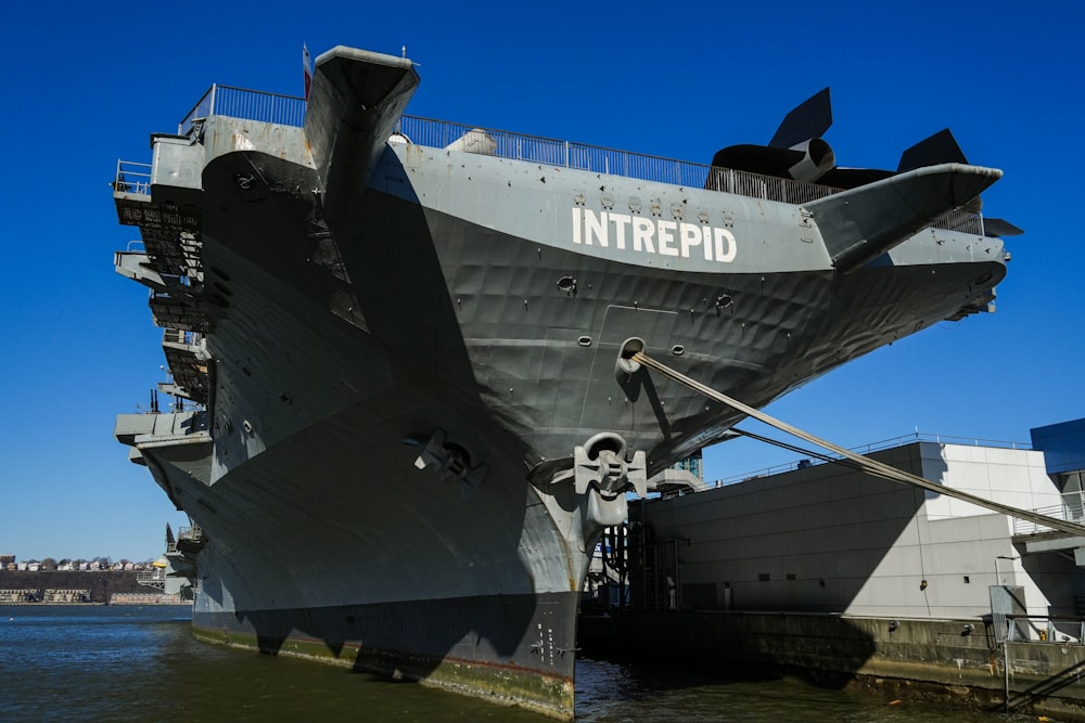 a large ship is docked at a dock