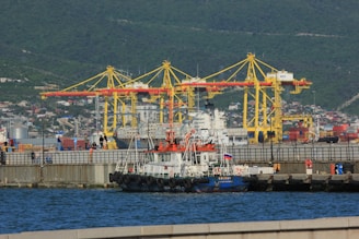 a large boat in the water next to a dock
