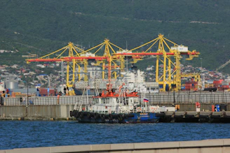 a large boat in the water next to a dock