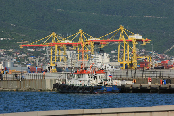 a large boat in the water next to a dock