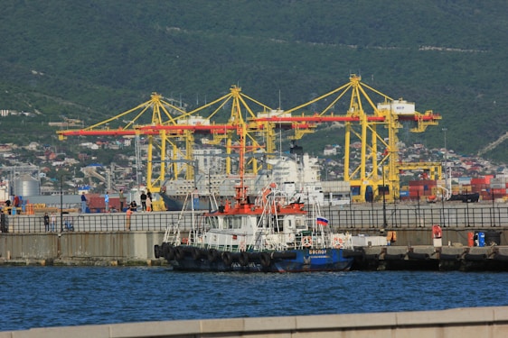 a large boat in the water next to a dock