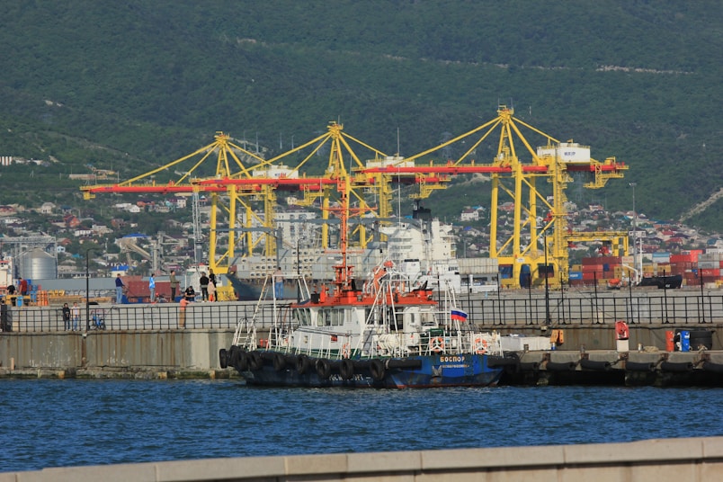 a large boat in the water next to a dock
