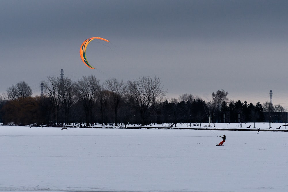 a person is para sailing in the snow