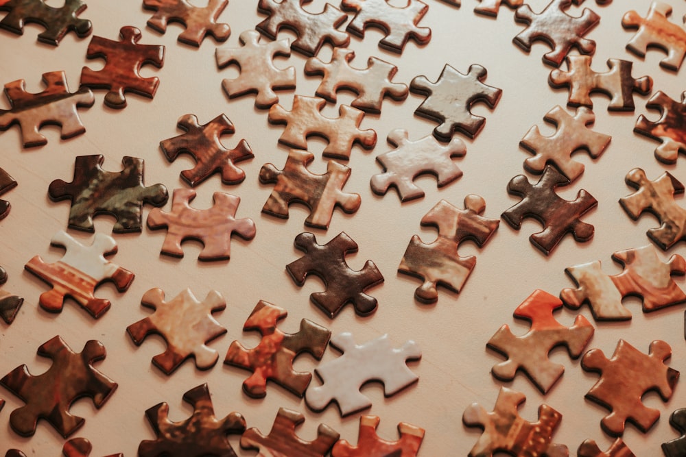 a large group of puzzle pieces sitting on top of a table