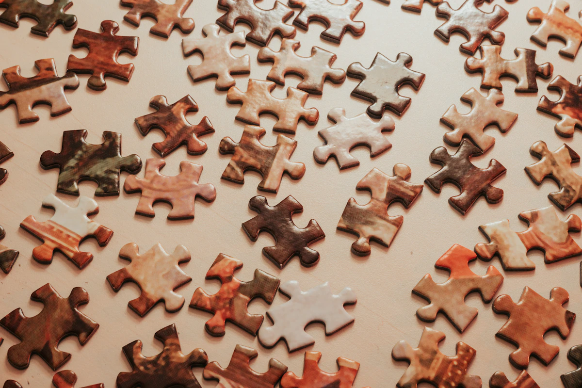 Detailed jigsaw puzzle pieces arranged across a table