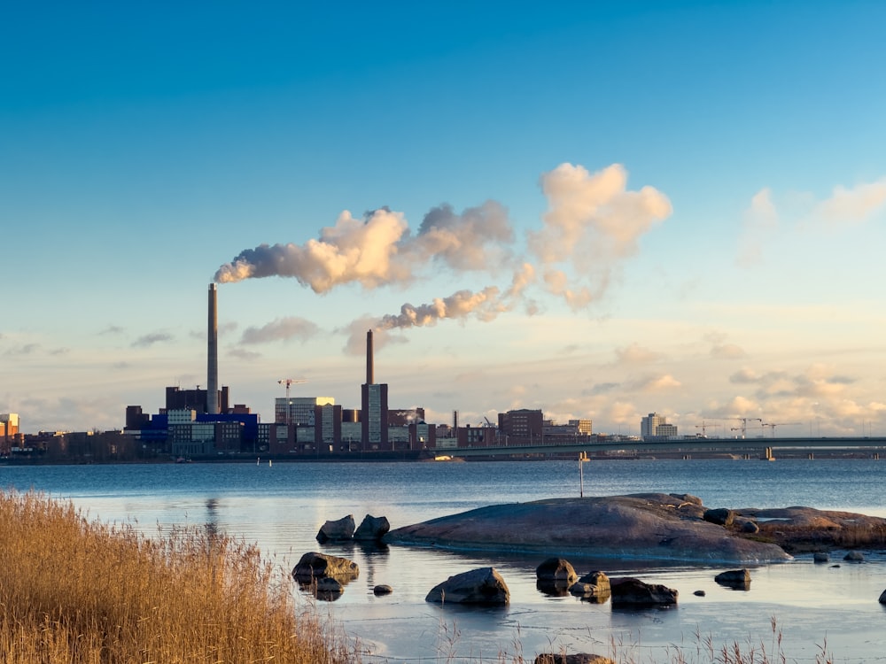 a view of a city with smoke coming out of the stacks