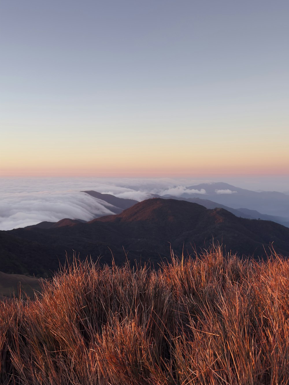 a view of a mountain range with low lying clouds