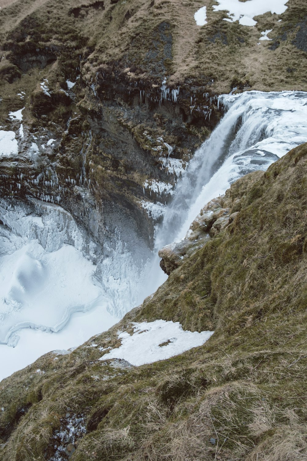 a man standing on top of a snow covered mountain